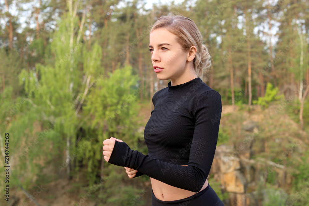 Sporty young woman running outdoors in morning Sporty young woman running outdoors in morning