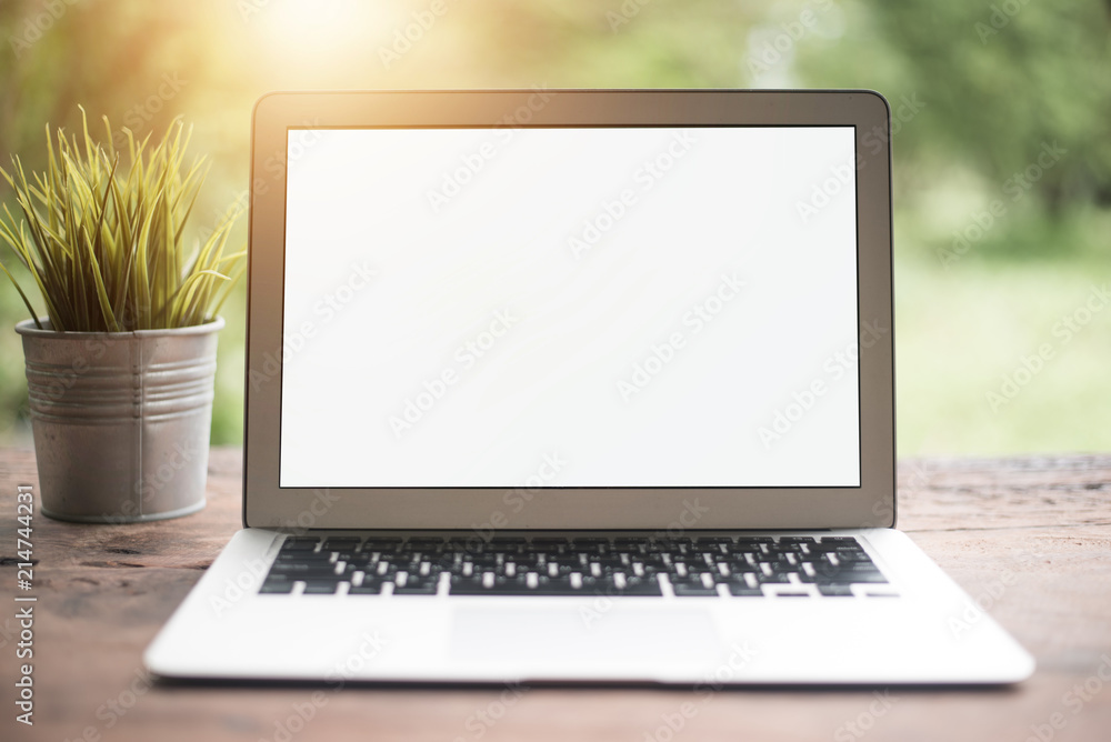 Computer laptop on table with green bokeh background. Computer laptop on table with green bokeh background.