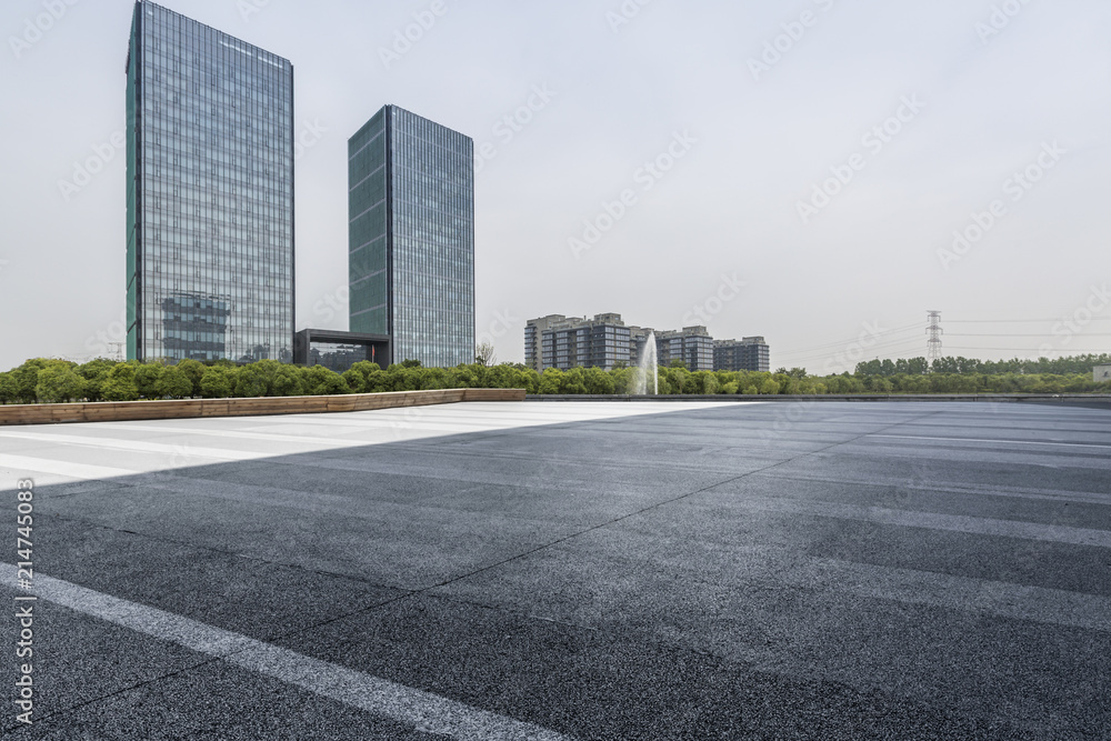 Panoramic skyline and modern business office buildings with empty road,empty concrete square floor Panoramic skyline and modern business office buildings with empty road,empty concrete square floor