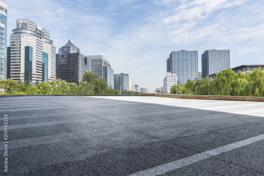 Panoramic skyline and modern business office buildings with empty road,empty concrete square floor Panoramic skyline and modern business office buildings with empty road,empty concrete square floor