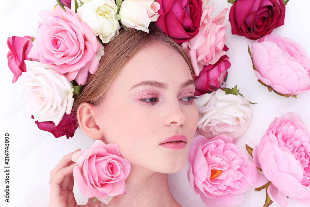 Portrait of a beautiful blonde woman with flowers in her hair. Portrait of a beautiful blonde woman with flowers in her hair.