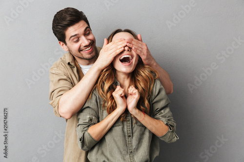 Portrait of a happy young couple , man covering