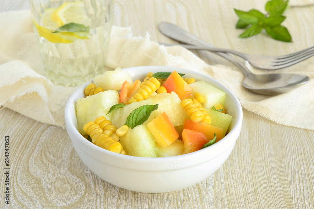 Salad with melon, corn and sweet pepper