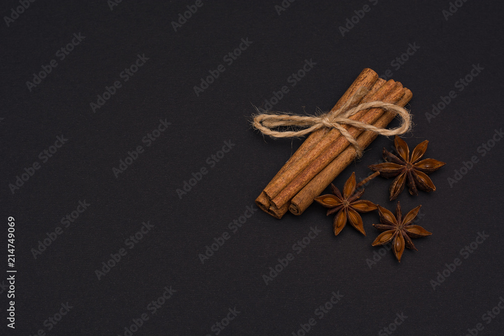 cinnamon sticks and cardamom on a black background top view with copy space for text cinnamon sticks and cardamom on a black background top view with copy space for text