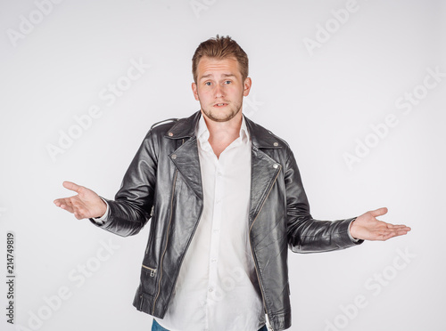 portrait of young man in black eather jacket isolated on a white background. Emotion and people concept. photo