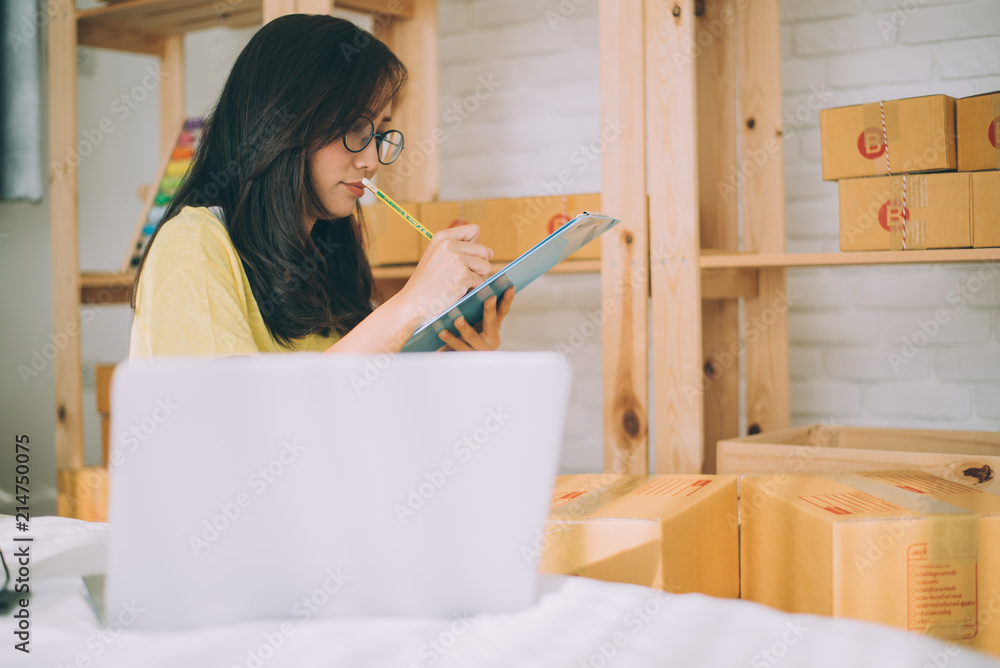 Young Asian Woman Working at home, Young business start up online seller owner, Delivery Project, Woman with Online Business or SME Concept. Young Asian Woman Working at home, Young business start up online seller owner, Delivery Project, Woman with Online Business or SME Concept.