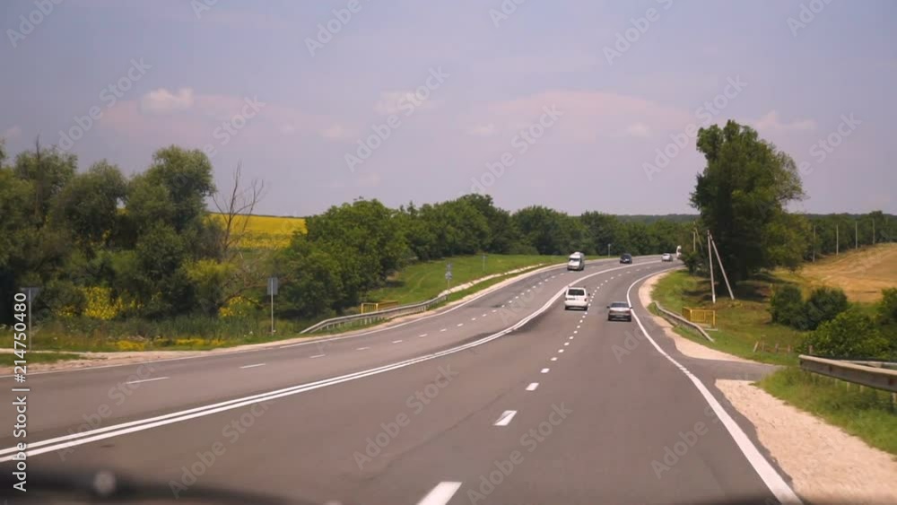 shot of a car as it travels down a country highway, other vehicles can been seen in the adjoining lanes. shot of a car as it travels down a country highway, other vehicles can been seen in the adjoining lanes.