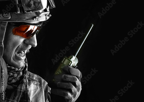 military man with portable radio transceiver photo