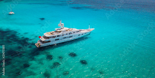 Fototapeta Big luxury yacht anchoring in shallow water,