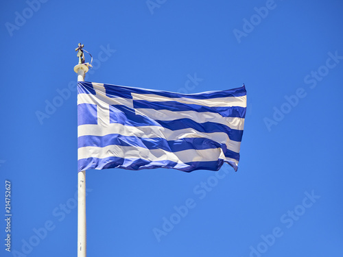 Official flag of Greece waving on a blue sky.