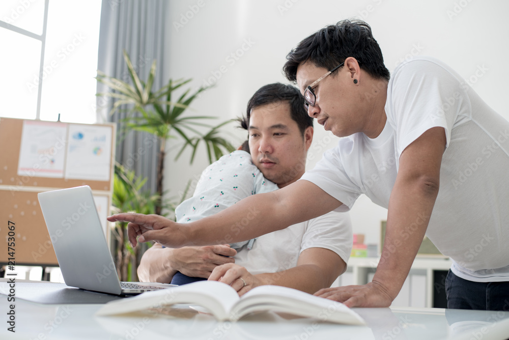 Two freelance men and daughter working with laptop at home. Two freelance men and daughter working with laptop at home.