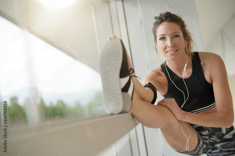 Fitness girl stretching after workout Fitness girl stretching after workout