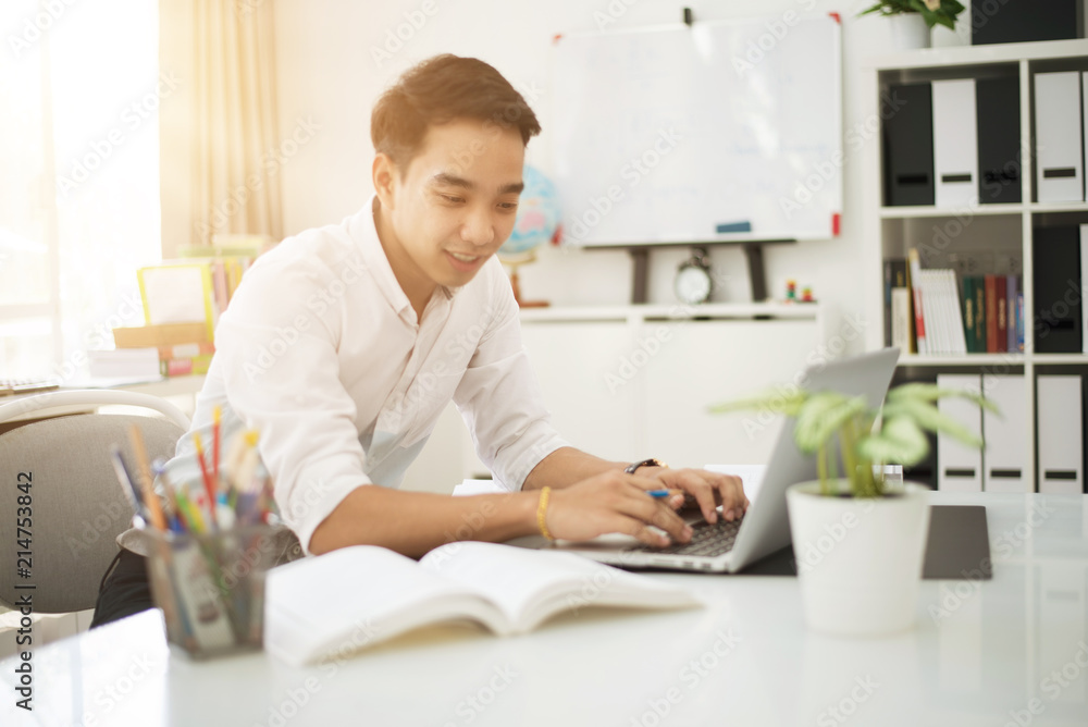 Asian young businessman working at his office. Asian young businessman working at his office.