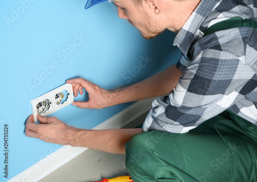 Male electrician repairing ...