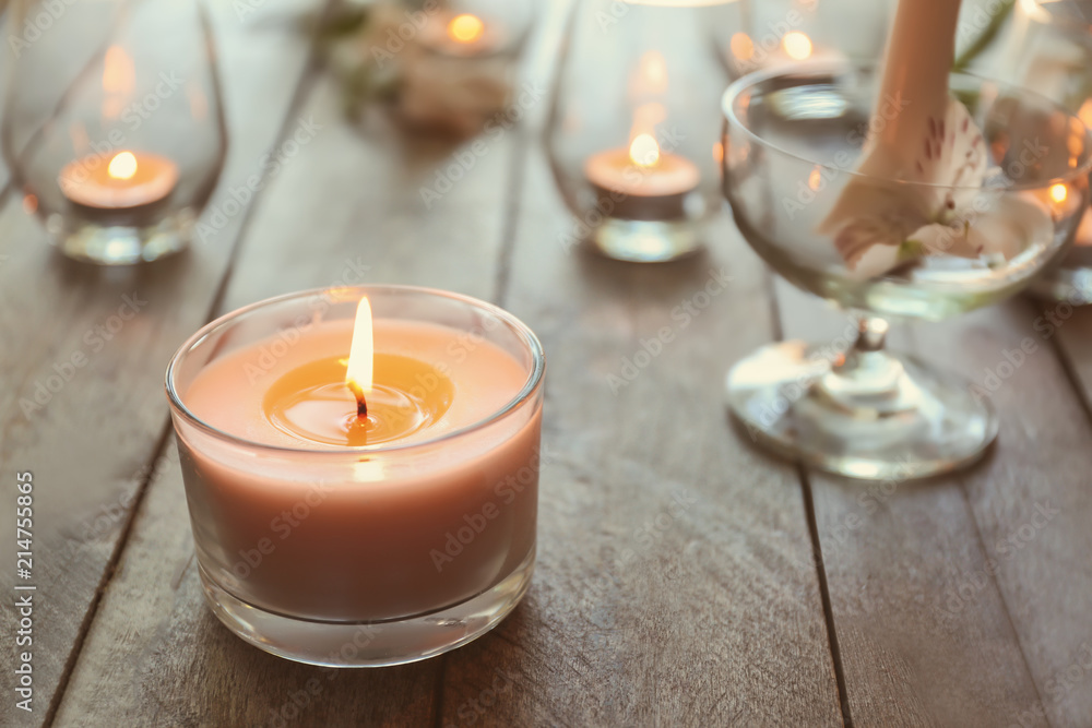Beautiful burning candle on wooden table Beautiful burning candle on wooden table