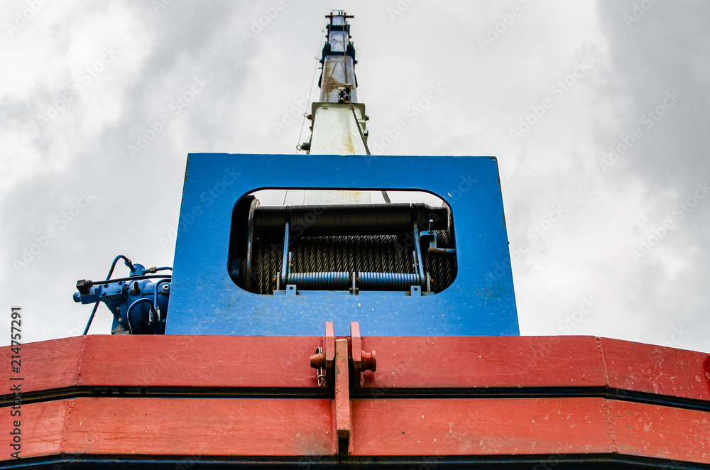 raised boom of a crane with a tensioned cable to the winch raised boom of a crane with a tensioned cable to the winch
