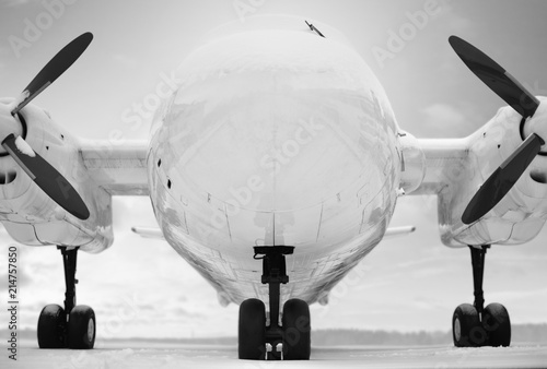 The turboprop aircraft is parked for the winter. Black and white style