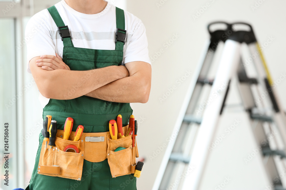 Electrician with tools indoors Electrician with tools indoors