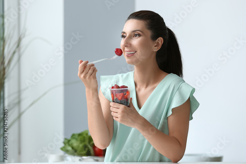 Woman eating fresh berries ...