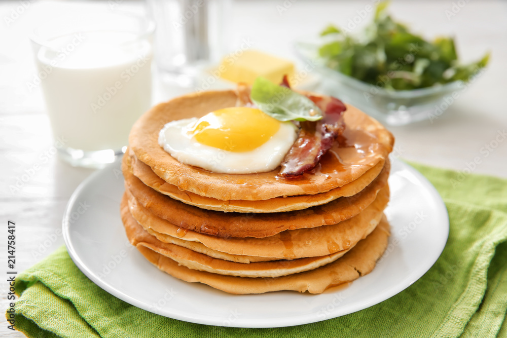 Plate with tasty pancakes, fried egg and bacon on table Plate with tasty pancakes, fried egg and bacon on table