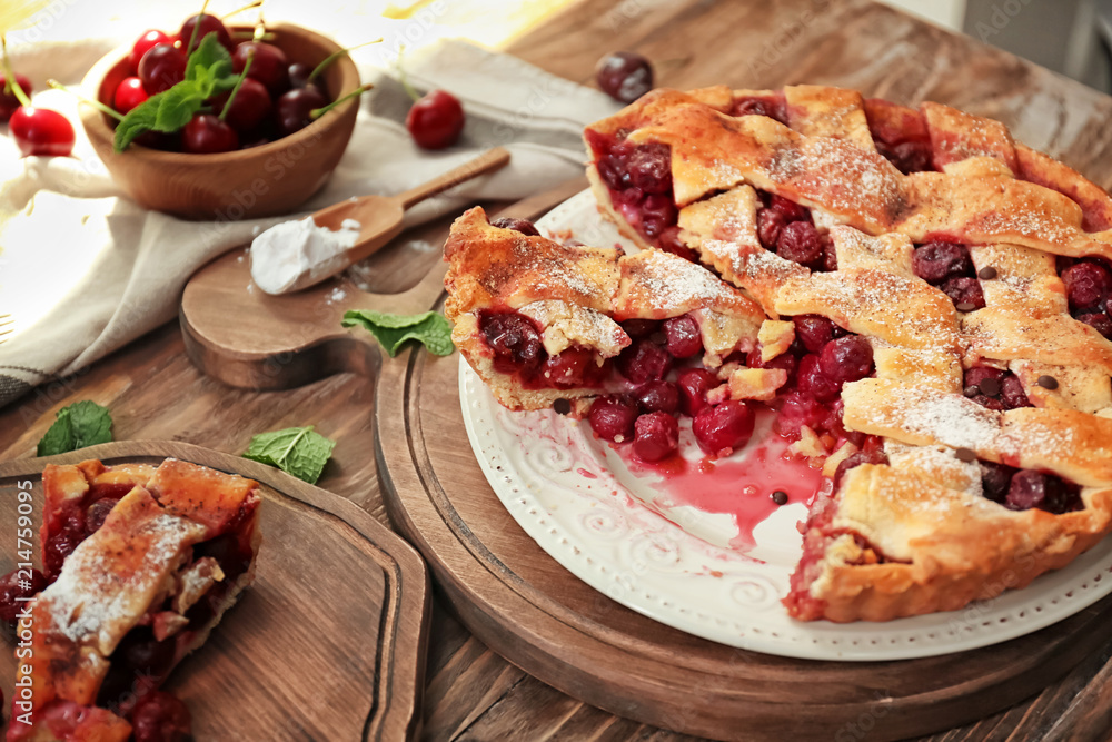Plate with delicious homemade cherry pie on wooden table
