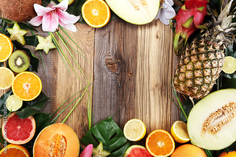 Assortment of tropical fruits with leaves of palm trees and exotic plants Assortment of tropical fruits with leaves of palm trees and exotic plants