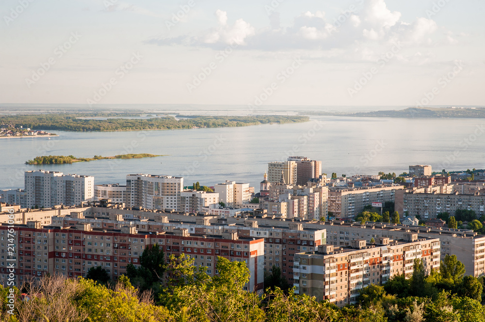 Obraz premium Saratov, Russia, view of the houses, the Volga River, the bridge to Engels. The landscape of the city from a height.