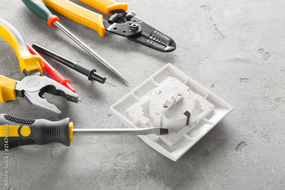 Different electrician's tools with socket on light background