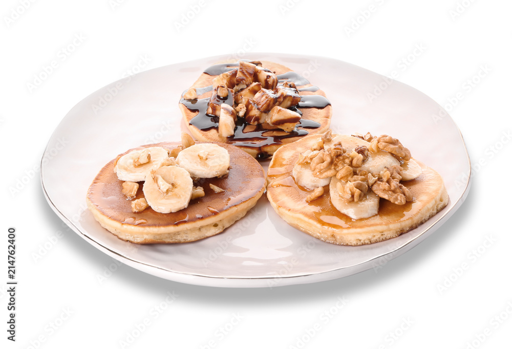 Plate with tasty pancakes, walnuts and sliced banana on white background Plate with tasty pancakes, walnuts and sliced banana on white background