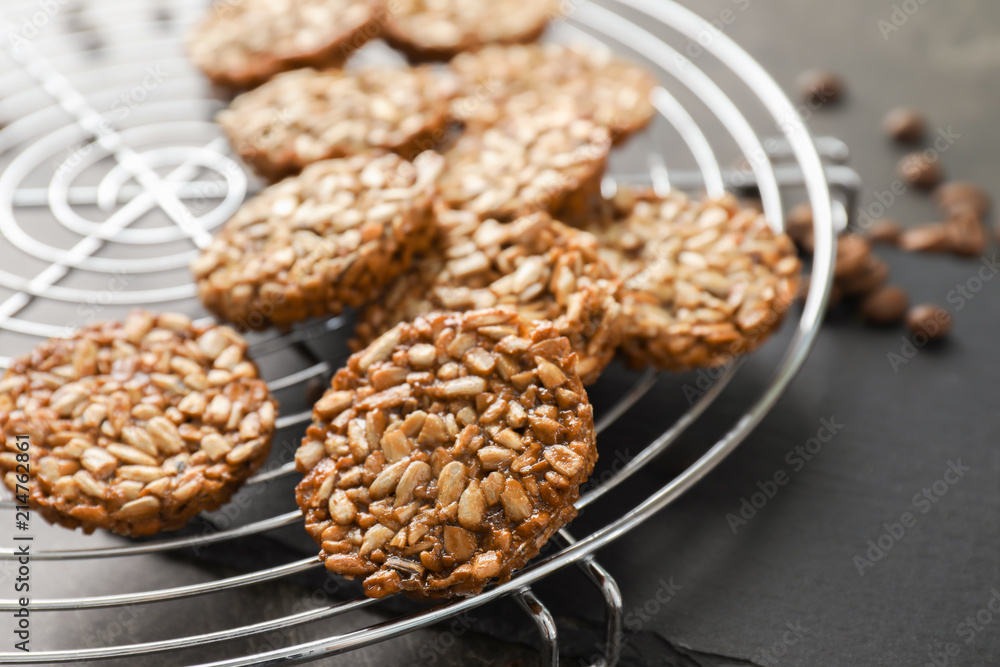 Cooling rack with tasty brittles on table, closeup Cooling rack with tasty brittles on table, closeup