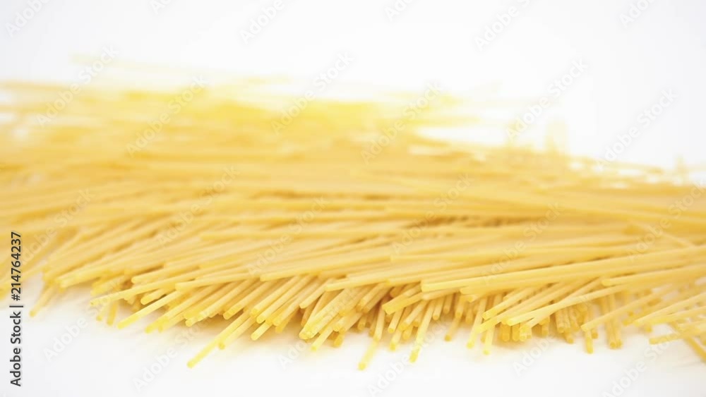 Italian pasta, spaghetti, falling in slow motion on white background Italian pasta, spaghetti, falling in slow motion on white background