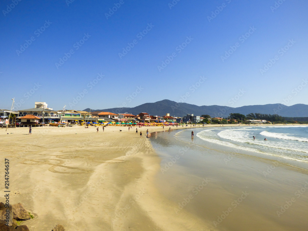 Restaurants and people enjoying the sunny day at Barra da Lagoa beach in Florianopolis, Brazil