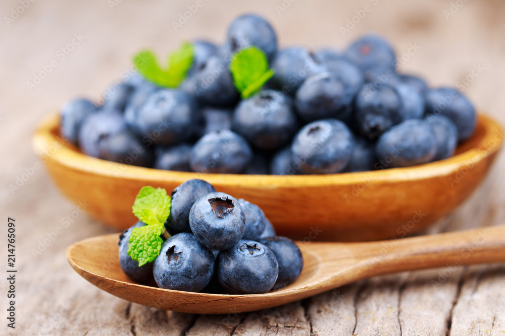 Blueberries in a wood bowl on a wooden table, Healthy eating and nutrition concept Blueberries in a wood bowl on a wooden table, Healthy eating and nutrition concept
