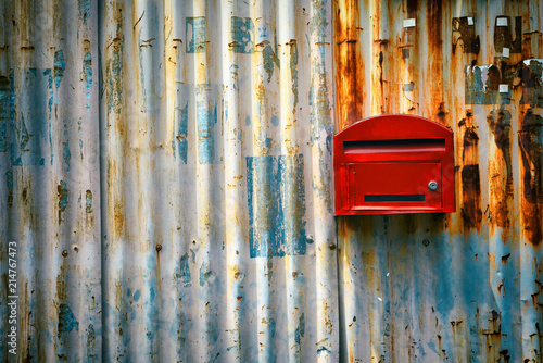 Red mailbox with zince tiles wall, red letter box with zince tiles wall photo