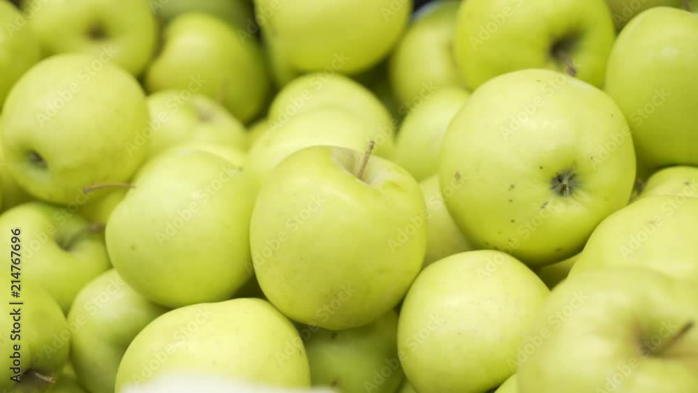 Green Apples Pile Closeup. Apples close-up lie on the storefront in the supermarket. Green Apples Pile Closeup. Apples close-up lie on the storefront in the supermarket.