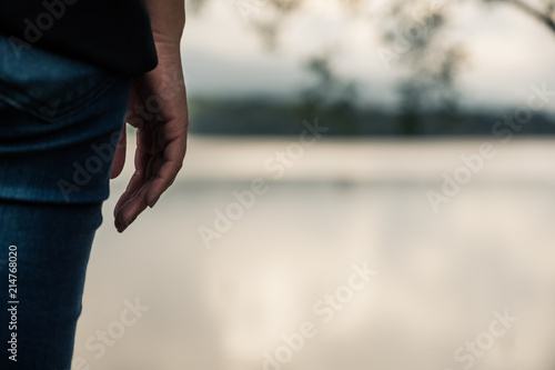 Closeup image of a woman standing alone by the river