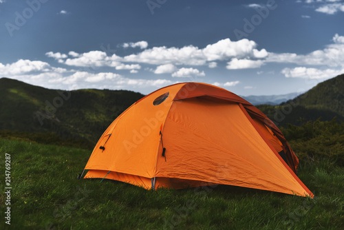 orange hiking tent in mountains
