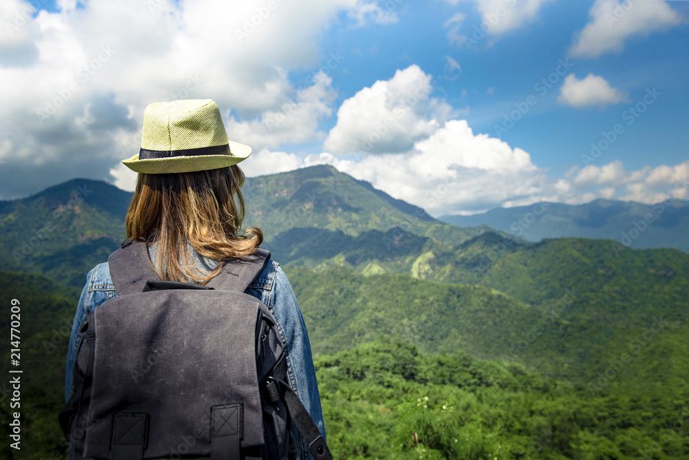 Young asian woman standing alone outdoor with wild forest mountains on background Travel Lifestyle and survival concept rear view Young asian woman standing alone outdoor with wild forest mountains on background Travel Lifestyle and survival concept rear view