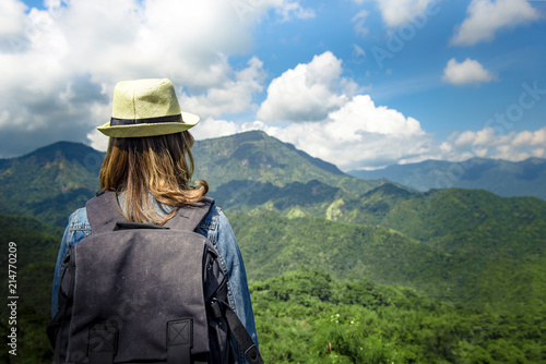 Young asian woman standing alone outdoor with wild forest mountains on background Travel Lifestyle and survival concept rear view