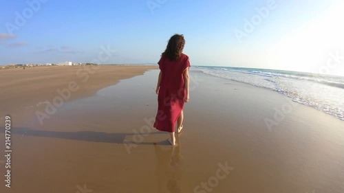 4k Video of a Woman with djellaba walking on a paradise beach in Morocco