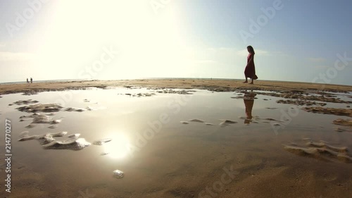 4k Video of a Woman with djellaba walking on a paradise beach in Morocco photo