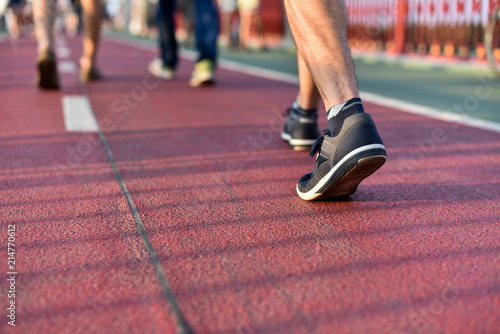 legs of man walking by bicycle path