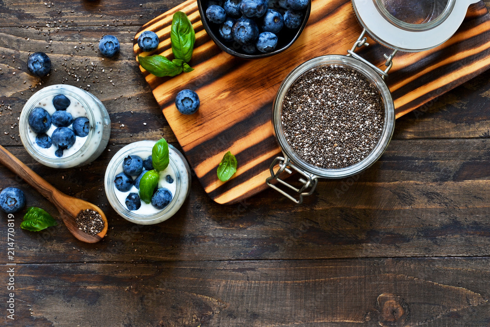 Homemade yogurt with sesena chia and blueberries that have a dark background. Proper nutrition. Homemade yogurt with sesena chia and blueberries that have a dark background. Proper nutrition.