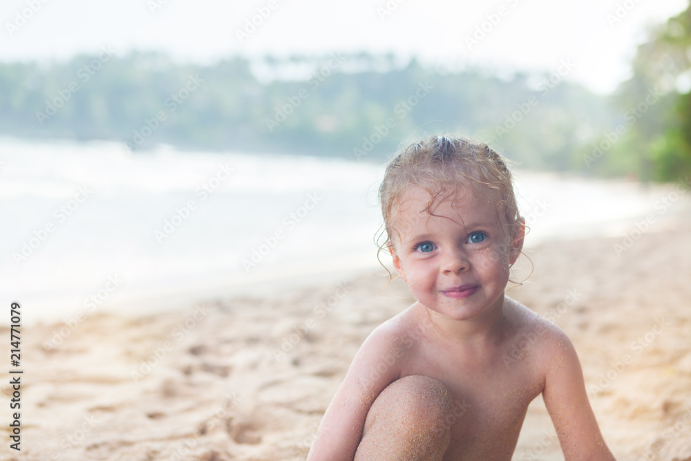 little girl at the beach smiling little girl at the beach smiling