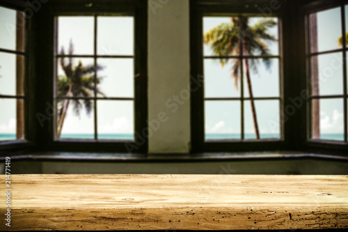 Table background of free space and window background with palms. Summer time. 