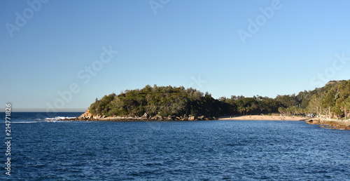 Shelly Beach and Cabbage Tree Bay Aquatic Reserve at Manly with sand and Tasman Sea. People relaxing on sandy Shelly beach at Manly.