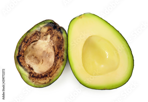 Fresh and rotten avocado halves on white background