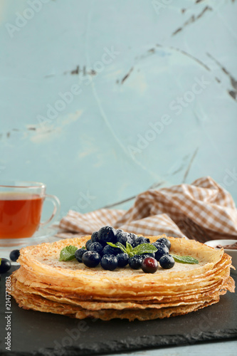 Stack of golden crepes with...