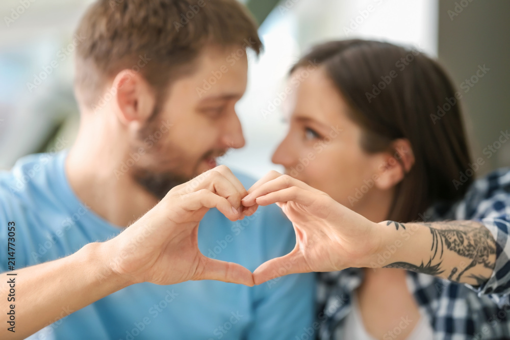 Happy lovely couple making heart with their hands, closeup Happy lovely couple making heart with their hands, closeup