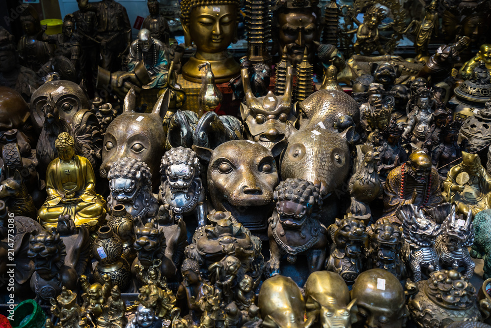 Fototapeta premium Selection of Chinese statues and souvenirs displayed in a gift shop at the Cat Street, Hong Kong, Sheung Wan